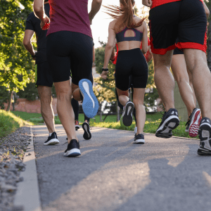 Group of people running outdoors, back view