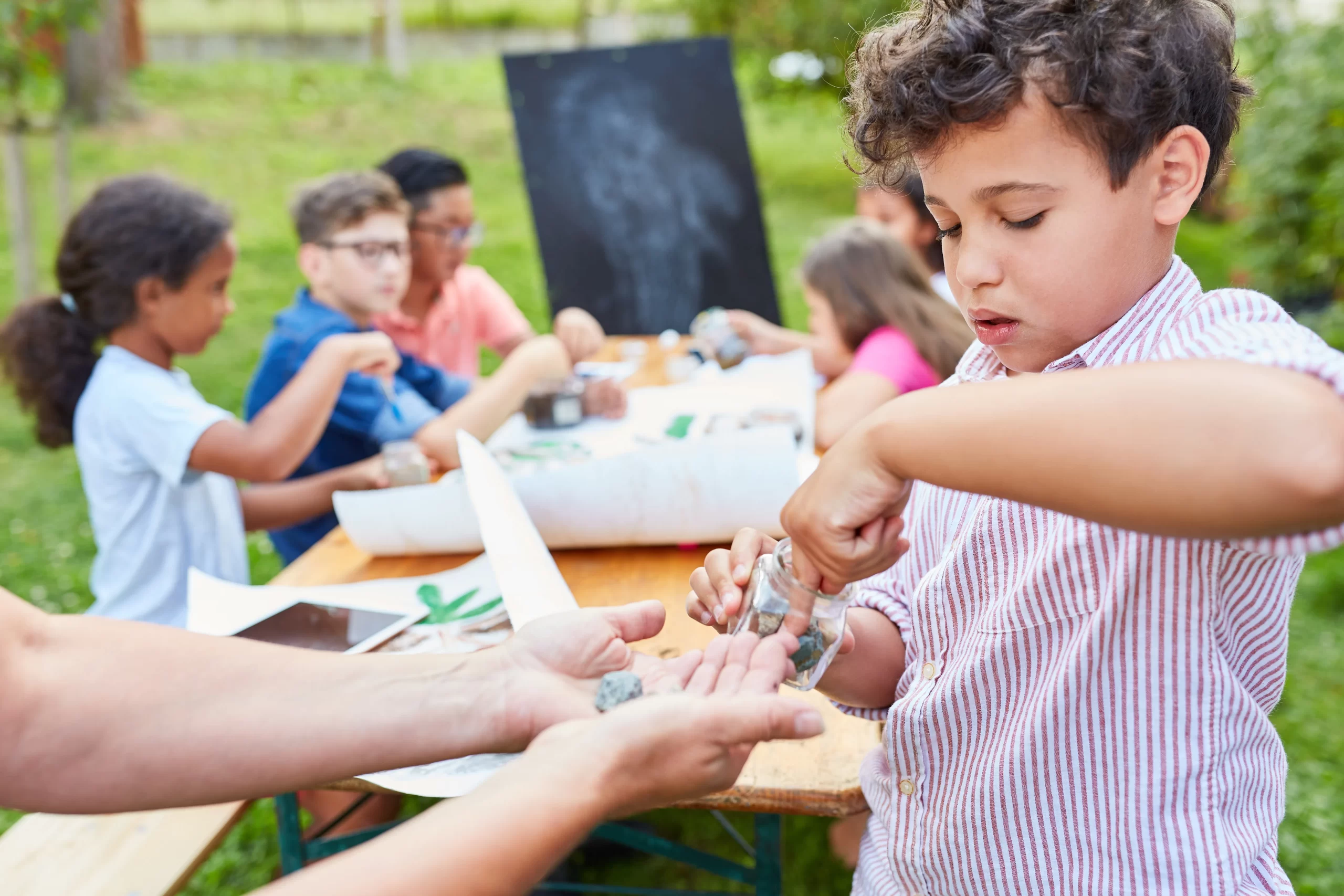 Children in the summer school in the tutoring camp learn about stones and minerals