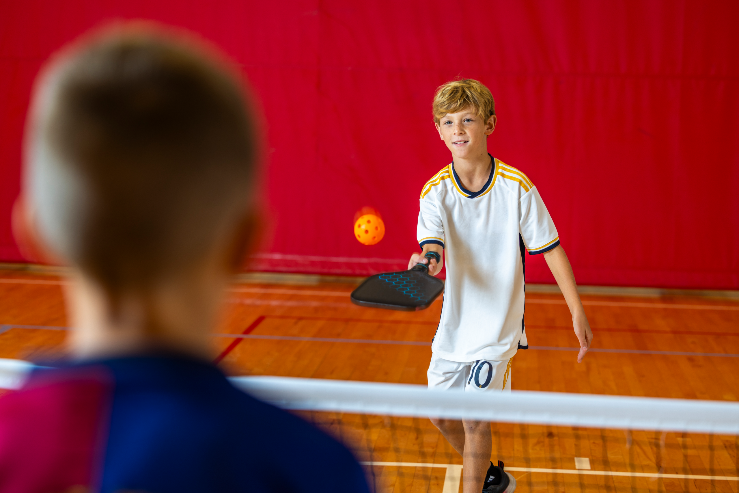 two young boys playing pickleball at the rec complex in fairview heights